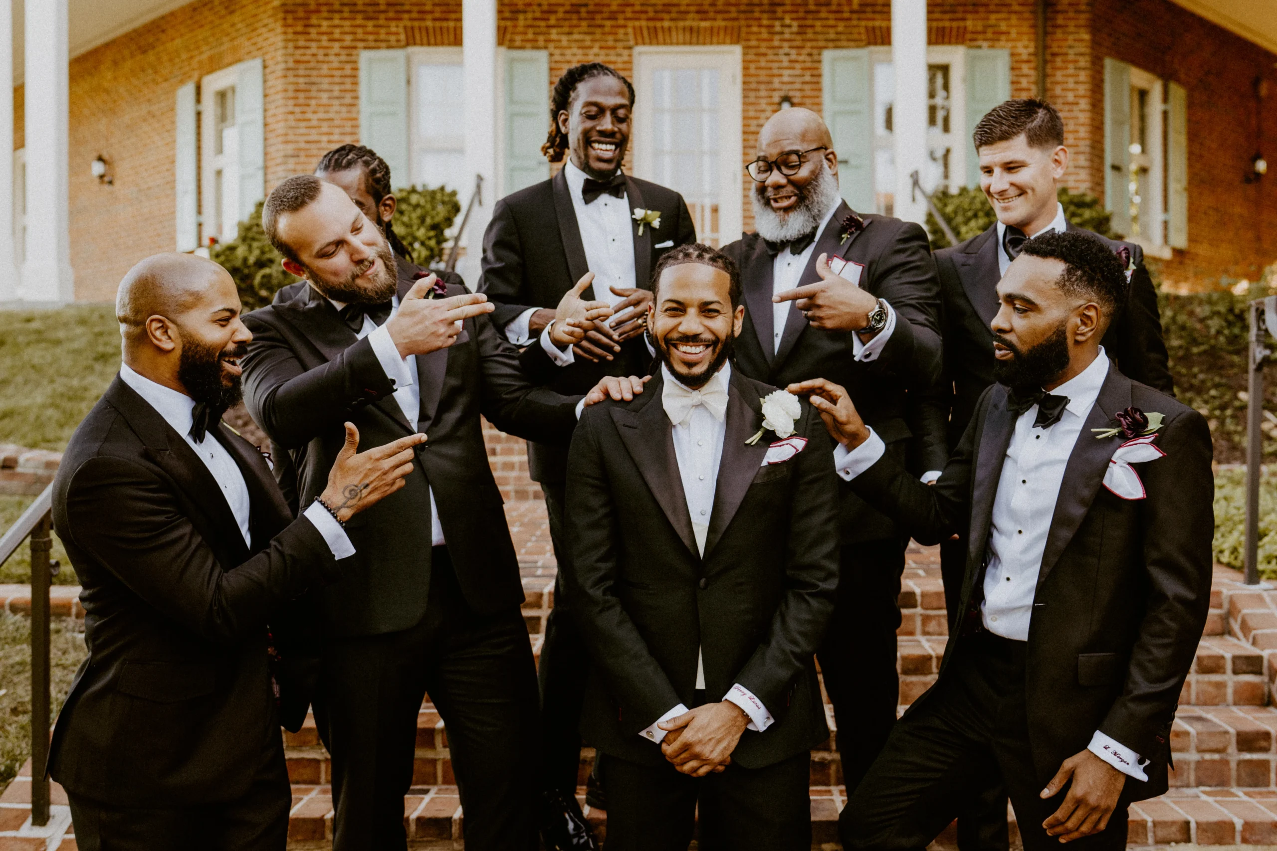 Young Man and Groomsmen on steps of city landmark