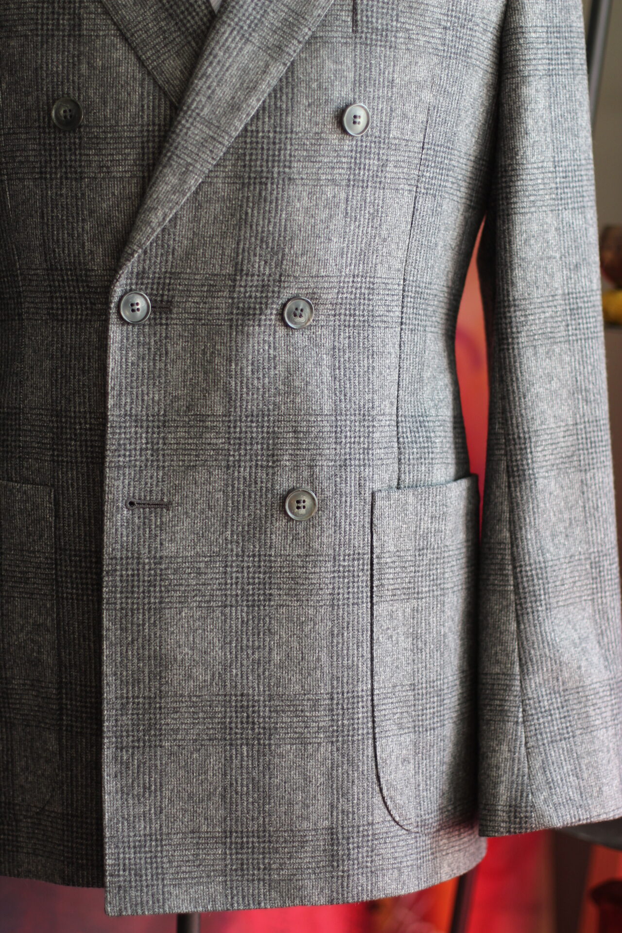 The Lucas Brothers Custom Menswear Double-breasted grey suit jacket with patch pockets